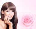 Asian beauty hand touch face with pink rose Royalty Free Stock Photo