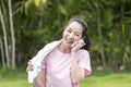 Asian Beauty and healthy woman exercise / doing meditation of yoga on exercise mat in the outdoor park - fitness, sport, yoga Royalty Free Stock Photo