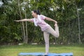 Asian Beauty and healthy woman exercise and doing meditation of yoga on exercise mat in the outdoor park -  fitness, sport , yoka Royalty Free Stock Photo