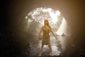 Asian beauty Standing post in a cave In front of the waterfall. Royalty Free Stock Photo