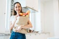 Asian beauty woman holding plenty of ingredients for cooking aft Royalty Free Stock Photo