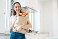 Asian beauty woman holding plenty of ingredients for cooking after shopping at supermarket People and lifestyles concept. Food and Royalty Free Stock Photo