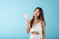 Asian beauty young woman holding pink portable electric mini fan near her face Royalty Free Stock Photo