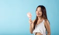 Asian beauty young woman holding pink portable electric mini fan near her face