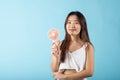 Asian beauty young woman holding pink portable electric mini fan near her face Royalty Free Stock Photo