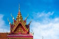 Asian bell temple roof showing intricate carvings and decorations with blue sky background