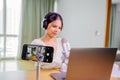 Asian blogger, podcaster or vlogger looking at camera and talking on video shooting with technology. Social media Royalty Free Stock Photo