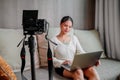 Asian blogger, podcaster or vlogger looking at camera and talking on video shooting with technology. Social media Royalty Free Stock Photo