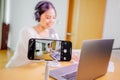 Asian blogger, podcaster or vlogger looking at camera and talking on video shooting with technology. Social media Royalty Free Stock Photo