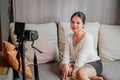 Asian blogger, podcaster or vlogger looking at camera and talking on video shooting with technology. Social media Royalty Free Stock Photo