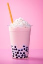 Asian boba tapioca bubble tea with cream topping on pink background, vertical photo.