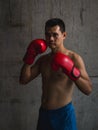 Asian boxer with red glove standing Royalty Free Stock Photo