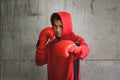 Asian Boxer in red hood with wall grunge background. Royalty Free Stock Photo