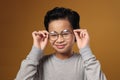 Asian Boy Adjusting Glasses, Eye Sight Problem Concept