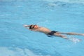 Asian boy back crawl in swimming pool Royalty Free Stock Photo