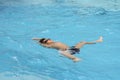 Asian boy back stroke swims in swimming pool Royalty Free Stock Photo