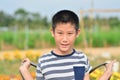 Asian boy with backpack in flower fields Royalty Free Stock Photo