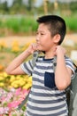 Asian boy with backpack in flower fields Royalty Free Stock Photo
