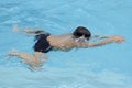 Asian boy breast stroke swims in swimming pool Royalty Free Stock Photo