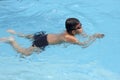 Asian boy breast stroke swims in swimming pool Royalty Free Stock Photo