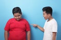 Asian boy bullying mocking other boy, fat boy get bullied at school Royalty Free Stock Photo