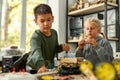 Imagine, Invent, Inspire. Asian boy and caucasian girl making their own vehicles at a stem robotics class. Inventions Royalty Free Stock Photo