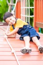 Asian boy climbing the rope