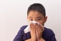 Asian boy cold flu illness tissue blowing runny nose Royalty Free Stock Photo