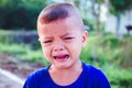 Asian boy crying on the street Royalty Free Stock Photo