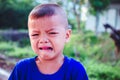 Asian boy crying on the street Royalty Free Stock Photo