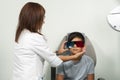 Asian boy in a duochrome test review with red and green 3D glasses