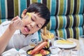 Asian boy eating French fries happily Royalty Free Stock Photo