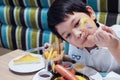 Asian boy eating French fries happily Royalty Free Stock Photo