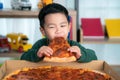Asian boy eating pizza Royalty Free Stock Photo