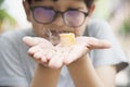 Asian boy eating smoking canny happily