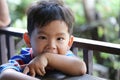 Asian boy is Feeling shy on food table Royalty Free Stock Photo