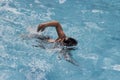 Asian boy front crawl swims in swimming pool Royalty Free Stock Photo