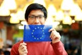 Asian boy in glasses holding flag of europe union Royalty Free Stock Photo