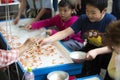 Tokyo, Japan May 3 ,2019 : an asian boy with a happy face giving a colander back to a seller after catching small fishes on his bo