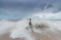 An Asian boy has felt happy and fun on the beach with a cloudy sky