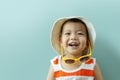 Asian boy with hat and yellow sunglasses laughing Royalty Free Stock Photo