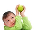 Asian boy holding a big green apple Royalty Free Stock Photo