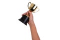 Asian boy holding a gold trophy cup for first place champion award isolated on white background. Royalty Free Stock Photo