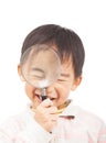 Asian boy holding magnifier and close eyes Royalty Free Stock Photo