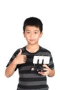 Asian boy holding radio remote control for helicopter, drone or plane and giving thumbs up, isolated on white background, Royalty Free Stock Photo