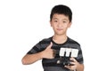 Asian boy holding radio remote control for helicopter, drone or plane and giving thumbs up,  isolated on white background Royalty Free Stock Photo