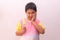 Asian boy with hypersensitive teeth eating eating a colorful frozen popsicle in the summer