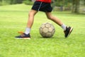 Asian boy kicking soccer ball Royalty Free Stock Photo