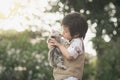 Asian boy kissing american short hair kitten