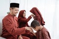Asian boy kissing his father`s hand when celebrating Happy Eid Ul- Royalty Free Stock Photo